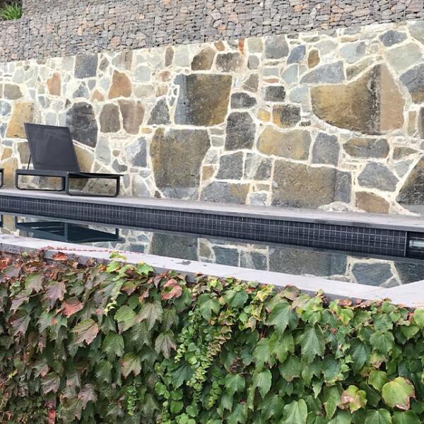 Custom stone surrounding swimming at Lorne property